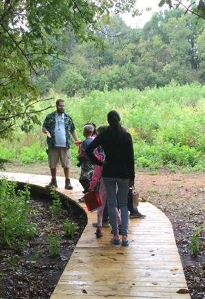 Students view a prairie from the boardwalk